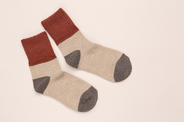 Warm colored socks on white background. Top view