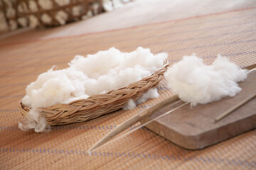 White natural cotton wool in bamboo basket. Selective focus
Thai and asian culture concept.