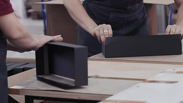 Workers laminated cardboard box. Modern factory of production cardboard box. Manufacture of cardboard boxes from paper. Enterprise for production package