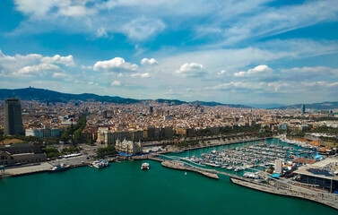 Fototapeta na wymiar view of Barcelona, the capital of Catalonia. Flight over the famous city coastline, port and cityscape in Spain, Europe.