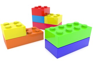 Toy bricks of different colors and sizes are stacked on top of each other on white