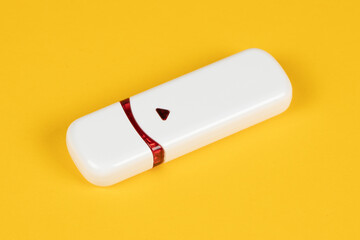 USB flash drive on yellow background