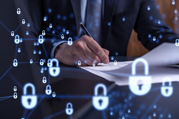 A businessman in formal wear signing the contract to prevent probability of risks in cyber...