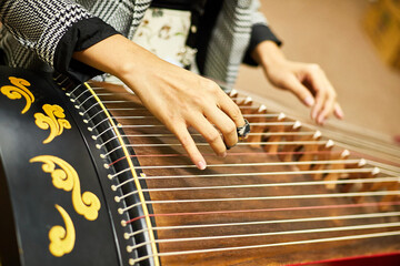 Close-up of a street musician playing on Guzheng - Chinese Horizontal Harp