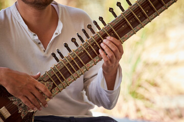 Close-up of a street musician playing Sitar