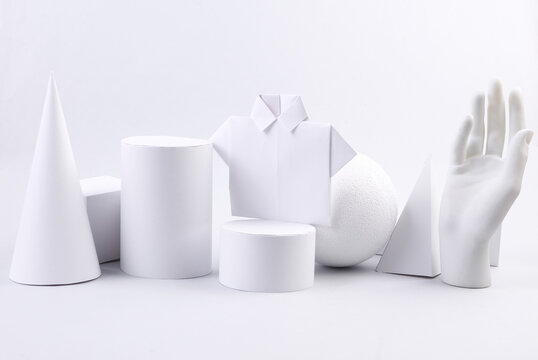Fashion showcase of origami shirt and geometric shapes on white background. Concept art