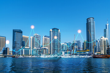 Fototapeta premium Skyscrapers of Dubai business downtown. International hub of trading and financial services of Western Asia. FOREX graph and chart concept. Double exposure. Dubai Canal waterfront.