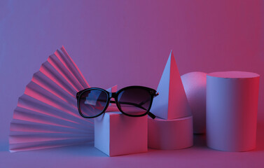 Fashion showcase with stylish sunglasses and geometric shapes in red blue light. Concept art