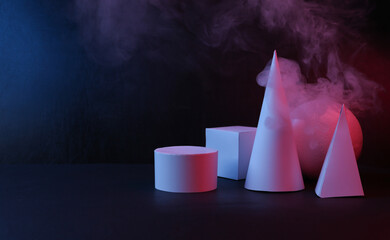 Geometric shapes with smoke in red-blue light on a black background. Concept art, minimalism