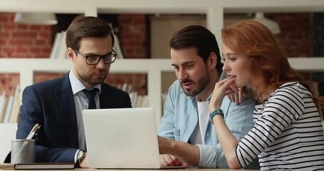 Insurance broker making special offer to young couple. Realtor show to clients services presentation on laptop. Family choose long term rental apartment during meeting with real estate agent in office