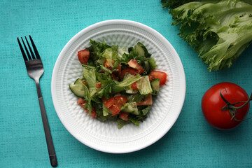 Salad of Frieze, tomatoes and cucumbers with olive oil.