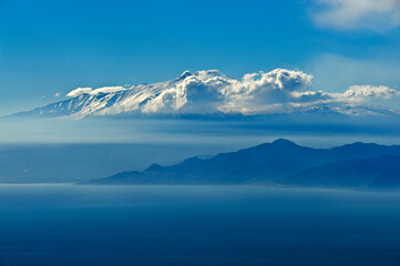 Fototapeta na wymiar The Strait of Messina seen from Calabria, in the clouds Mount Etna, Sicily, Italy, Europe