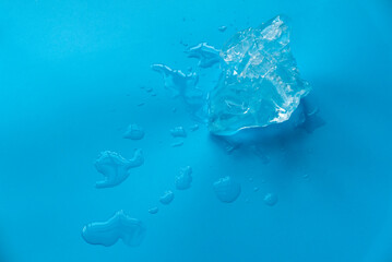 Fototapeta na wymiar Ice and water on a blue background.
