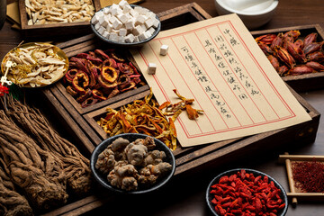 Ancient Chinese medicine books and herbs on the table