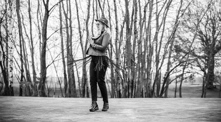 Woman wear eco leather green jacket, Fedora brown hat and vintage aviator glasses , belt with a fringe, trendy concept