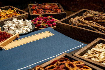Ancient Chinese medicine books and herbs on the table