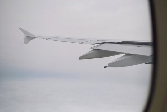 Low Angle View Of Airplane Flying In Sky