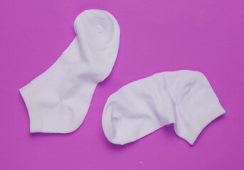 Pink socks on pink background. Minimalism fashion concept. Pastel color trend.