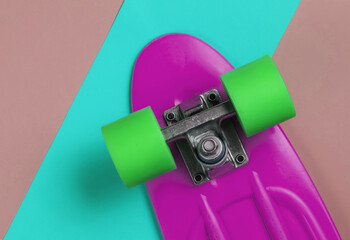 Cruiser board on colored paper background. Summer fun. Studio shot. Top view