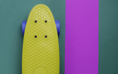 Cruiser board on colored paper background. Summer fun. Studio shot. Top view