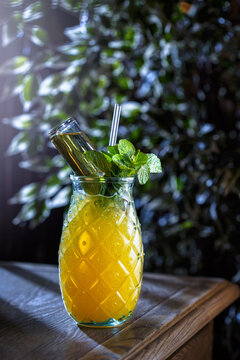 Yellow Coctail In Pineapple Glass With Mint