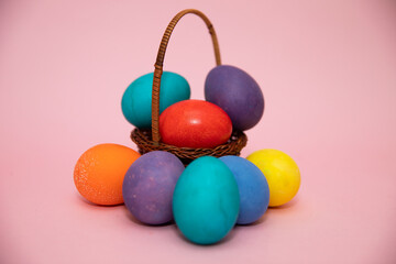Obraz na płótnie Canvas Small basket with beautiful colorful Easter eggs