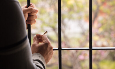 hands with hashish joint and bag with cannabis.Drug trafficking in prison Drug consumption and sale...