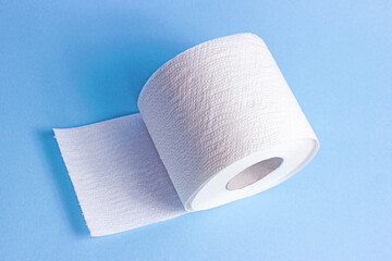 White toilet paper roll on light blue background.