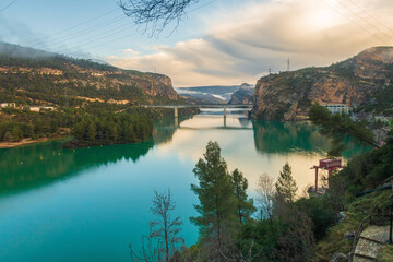 Fototapeta premium Natural environment of Cortes de pallás, in Valencia (Spain), with views of its mountains, Chirel Castle and its coniferous forests. On a sunny and cloudy day.