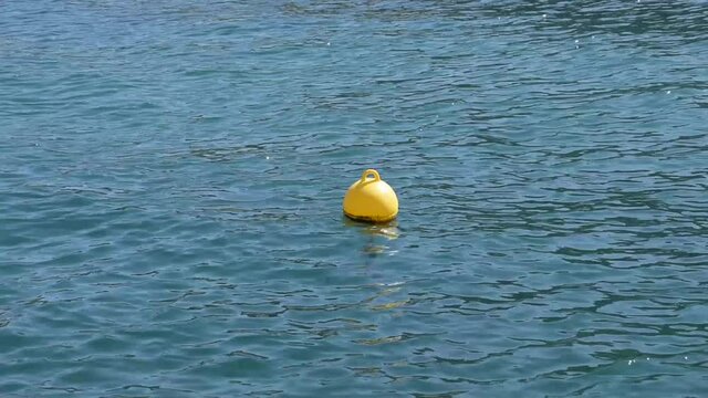 Seascape with yellow buoy in the water
