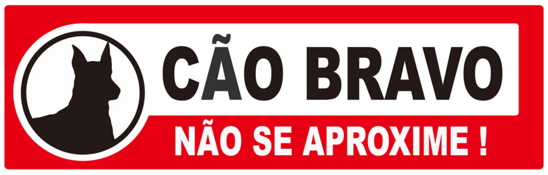 A sign that says in Portuguese language : angry dog.    Don't approach . Beware of dog