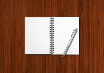 Blank open spiral notebook and pen isolated on dark wood
