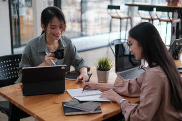 Business woman and partners in smart casual wear discussing business while sitting in the home office. Confident and successful team.