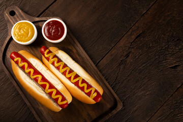 Hot dog with ketchup and yellow mustard.