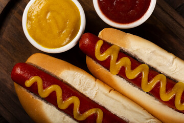Hot dog with ketchup and yellow mustard.