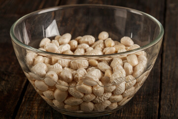 White beans in a clear vase in water ready for cooking. Close-up.