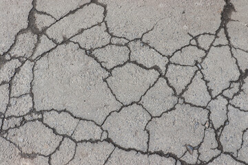 Cracked asphalt background. Old pavement texture with cracks. 