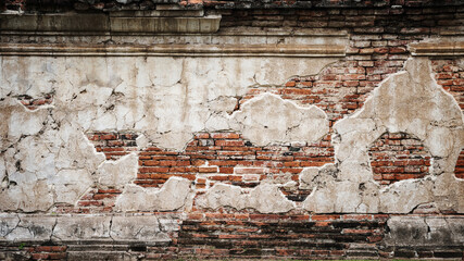 Old red brick wall with white stucco background