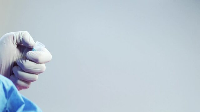 Blood test full tubes in doctor's hand with glove, on the white background, studio shoot.