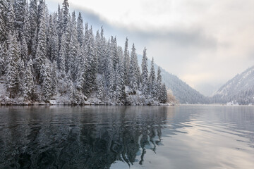 Mountain lake after snowfall. The Kulsai lake, Kazakhstan.