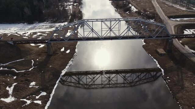 Metal railway train bridge over the river
Belarus Orsha Dnieper River. 
early spring Aerial footage from drone flying above