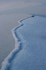 Cracked River Ice and Frost Close-up Winter Snow Surface Background 