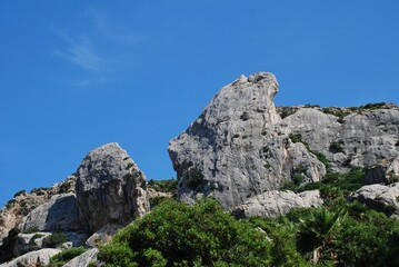 Fototapeta na wymiar The rocky peaks of the Tramuntana mountains in the Boquer valley trail near Puerto Pollensa on the Spanish island of Majorca 