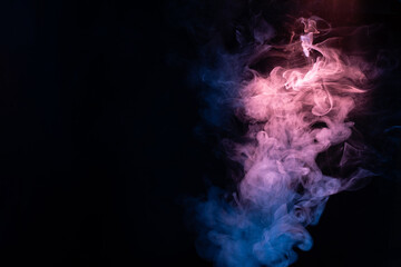 Fototapeta premium Blue and pink steam on a black background.