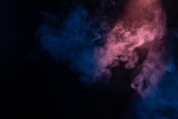 Fototapeta na wymiar Blue and pink steam on a black background.