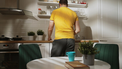 Man doing breakfast at sunny morning.