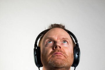 man in head phones short beard on a white background