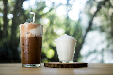 Iced Mocha coffee topping with milk foam and served with milk foam in glass