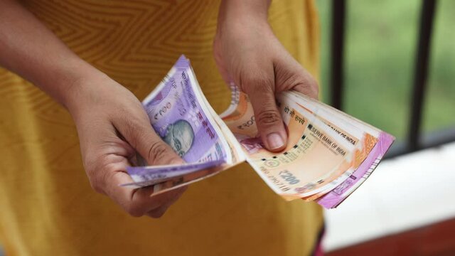 Counting Indian currency Rupee , hand giving Indian money 100, 200, 2000 rupees banknote Kerala India 4K slow motion video, footage. Business woman counting giving money cash new Indian currency notes