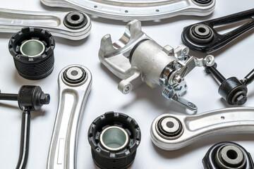 Obraz premium Car inspection. Auto motor mechanic spare or automotive piece on white background. Set of new metal car part. Automobile engine service.
